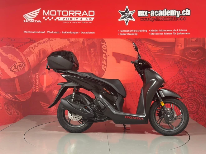 Buy a scooter – black motor scooter with top box and an upright riding position