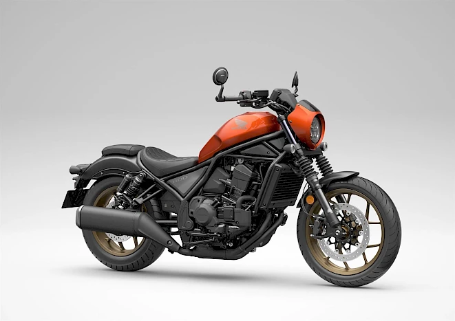 Orange Honda CMX1100 Rebel cruiser with gold rims, studio shot – category A cruiser motorcycle