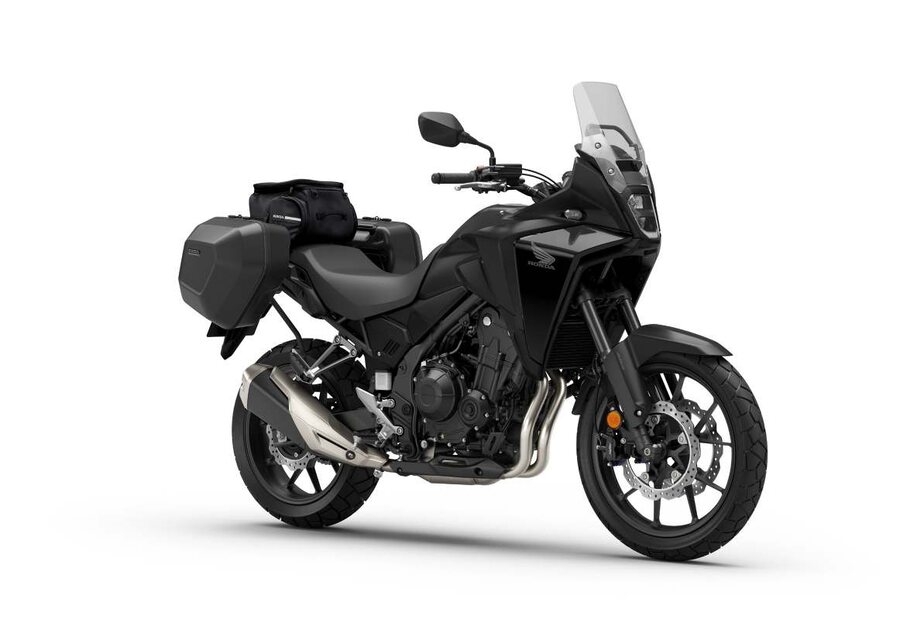Honda NX500 with side cases, luggage and a tall screen from the genuine accessory range